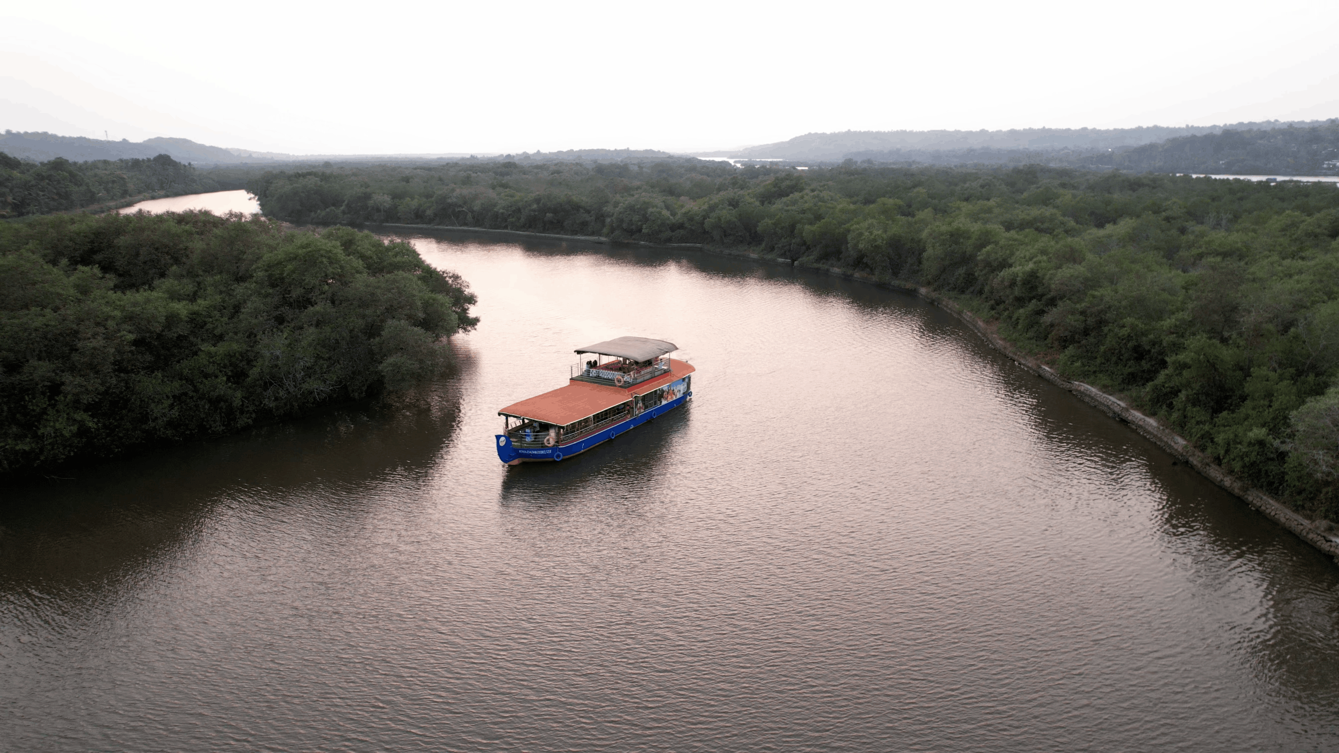 Sunset cruise during golden hour on the Vellikkeel backwater, Kannur